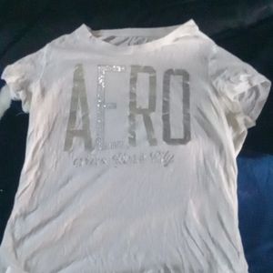 White Aero tee w/ pleated white skirt. Athletic outfit.